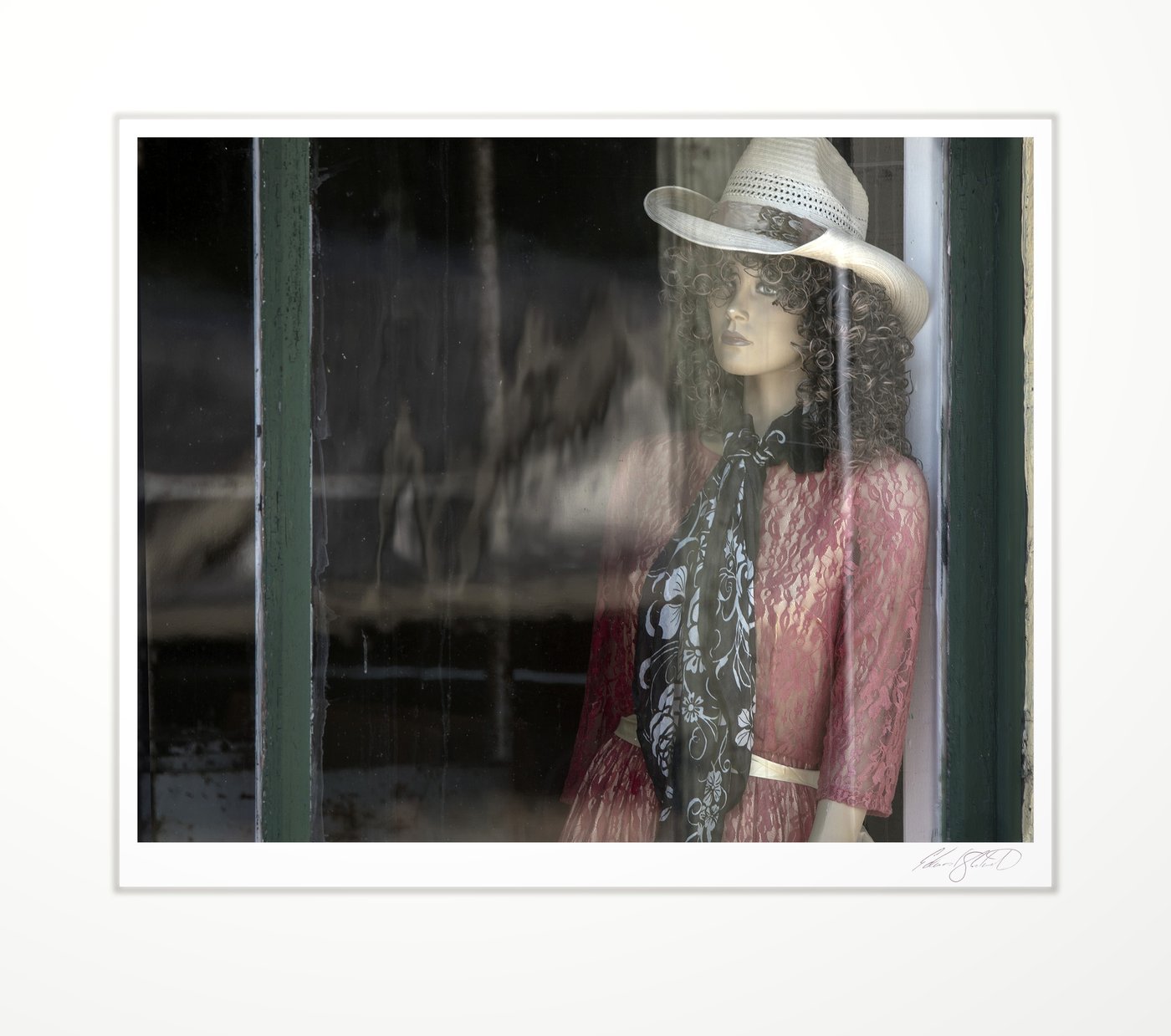 A vintage mannequin in an old shop window
