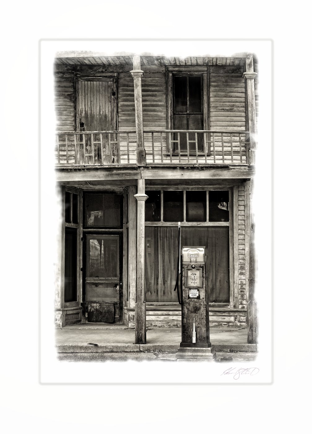 An old wooden storefront with a vintage gas pump and weathered balcony.