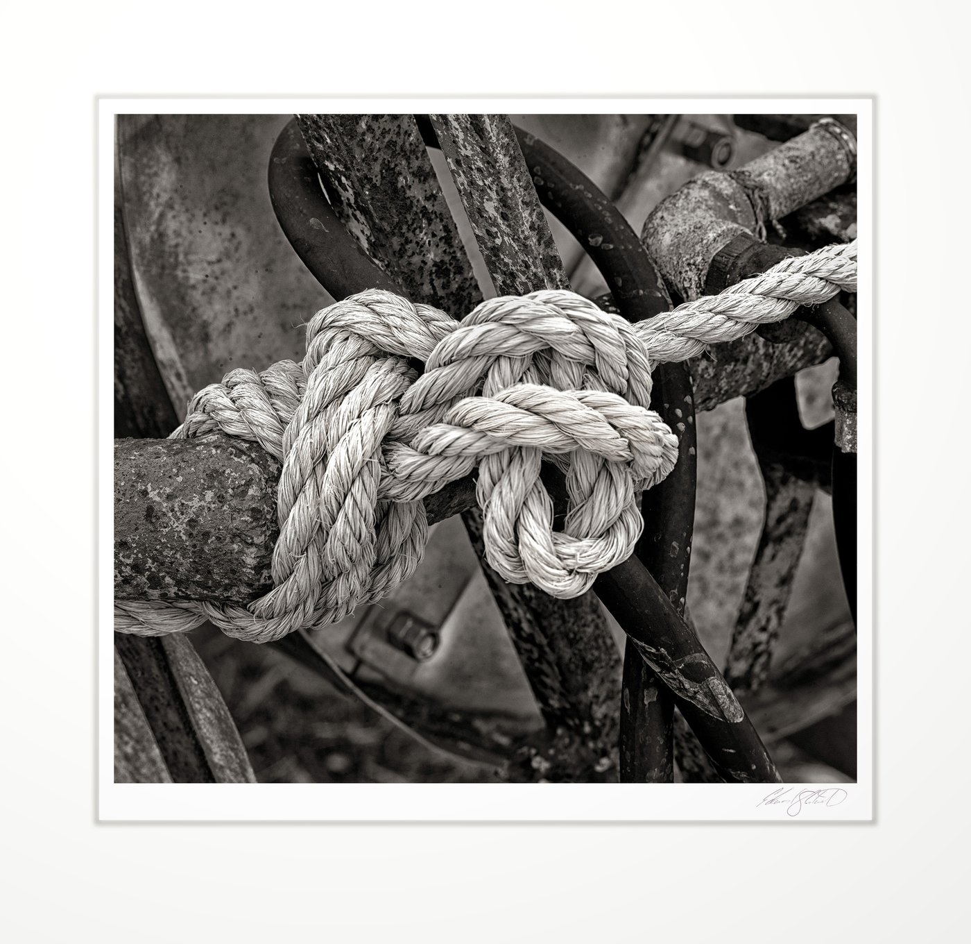 Rope knot on rusted machinery
