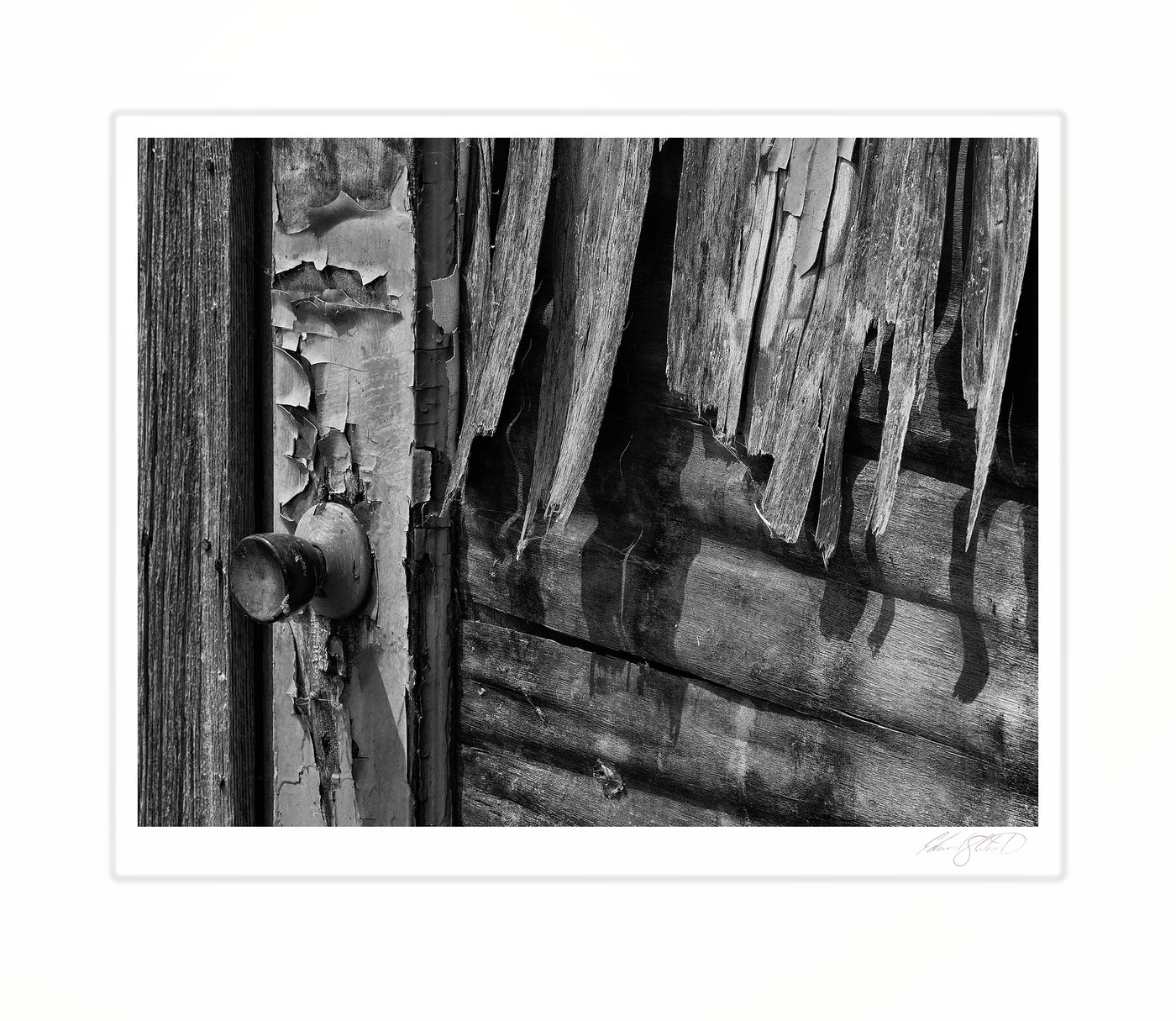A weathered door with peeling paint and an old doorknob.
