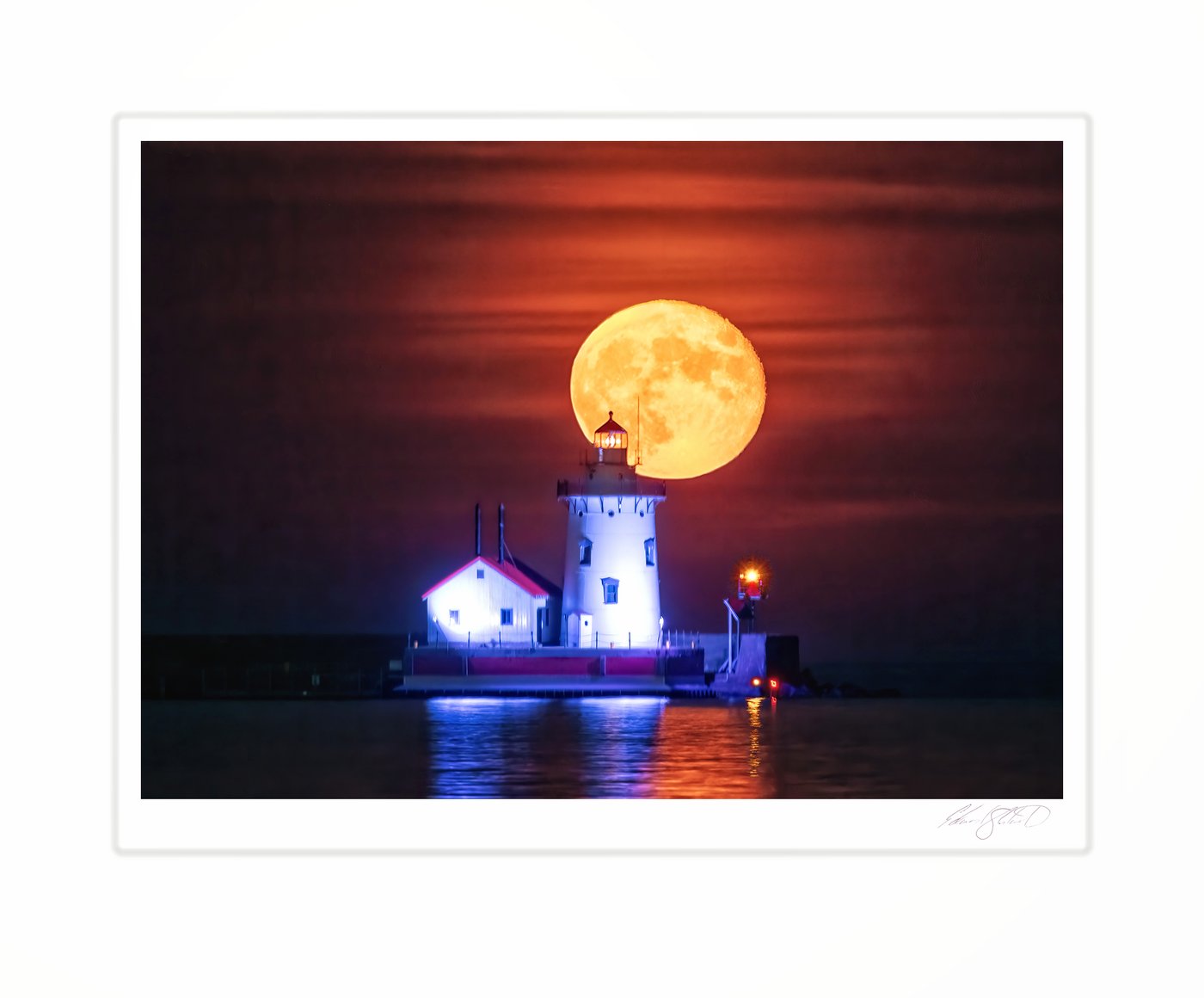 A large full moon rising behind a lighthouse against an orange sky