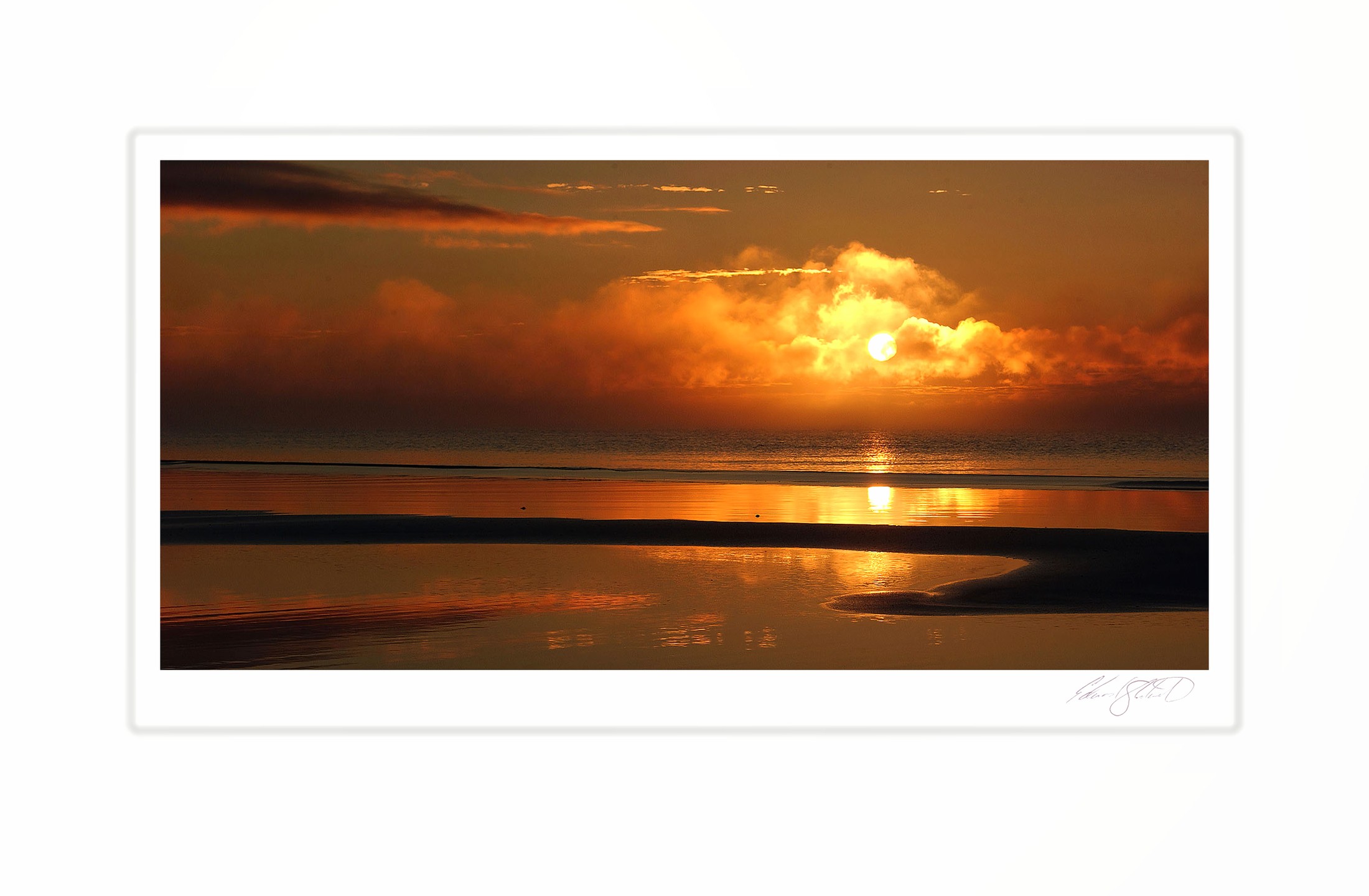 The sun rising through clouds over Lake Michigan