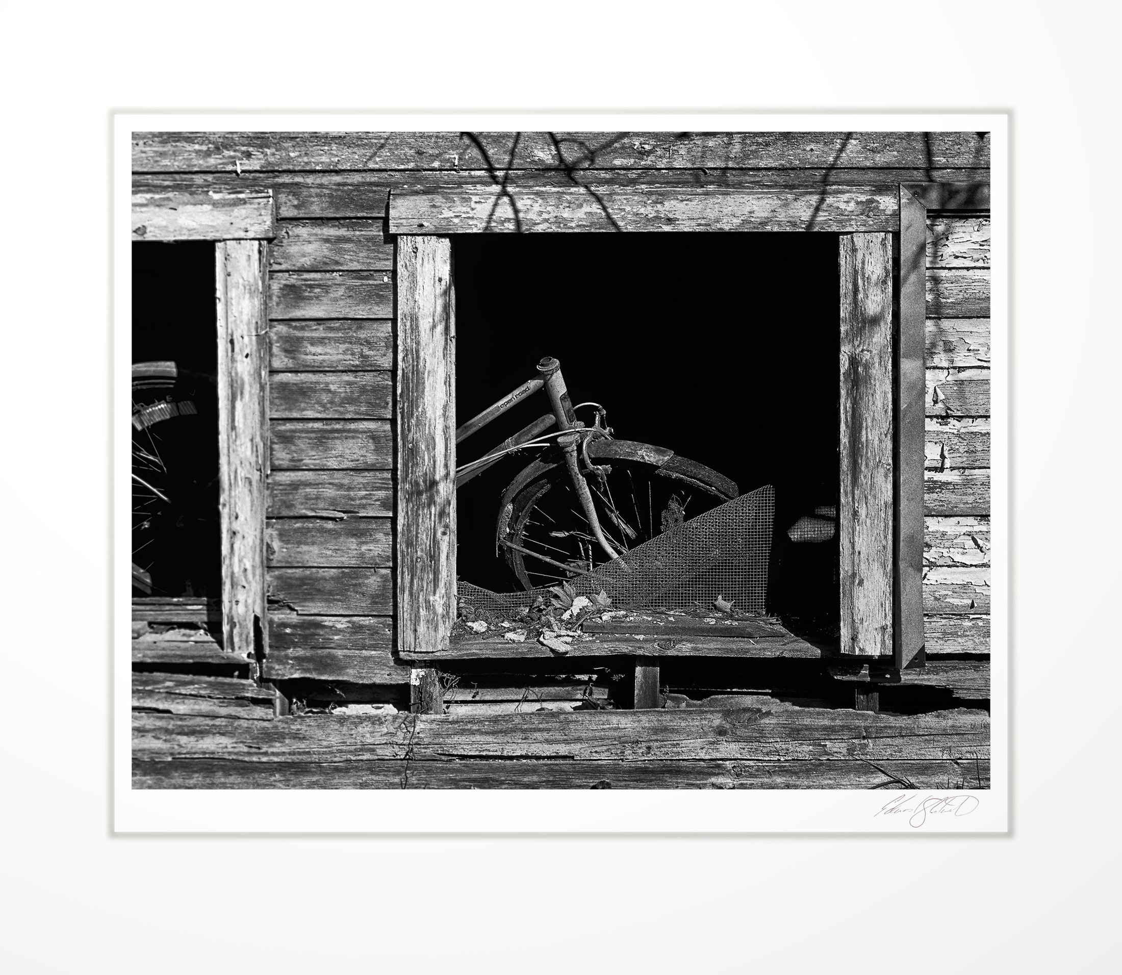 An old bicycle seen through a barn window