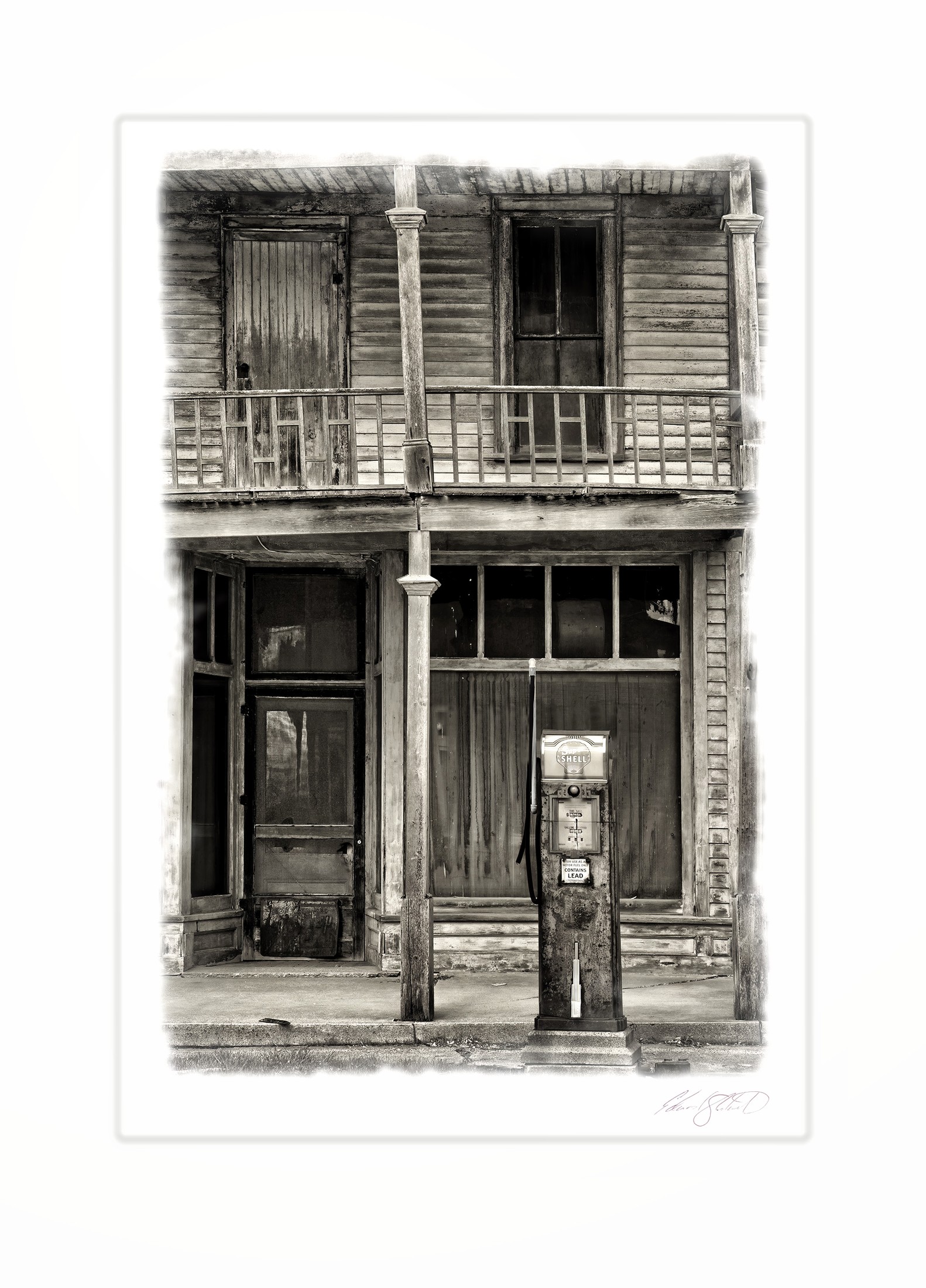 An old wooden storefront with a vintage gas pump and weathered balcony.