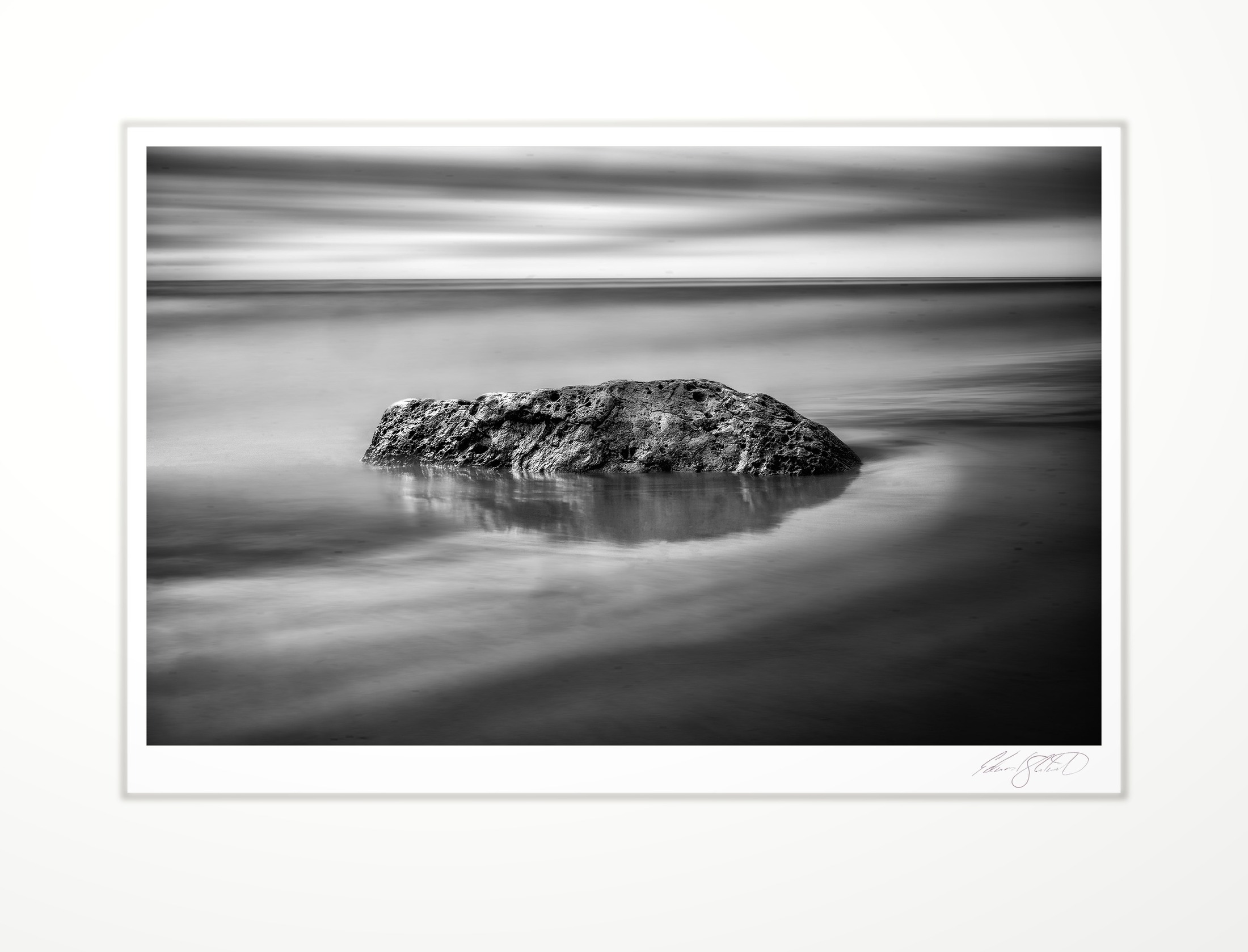 A solitary rock on a Lake Michigan shore