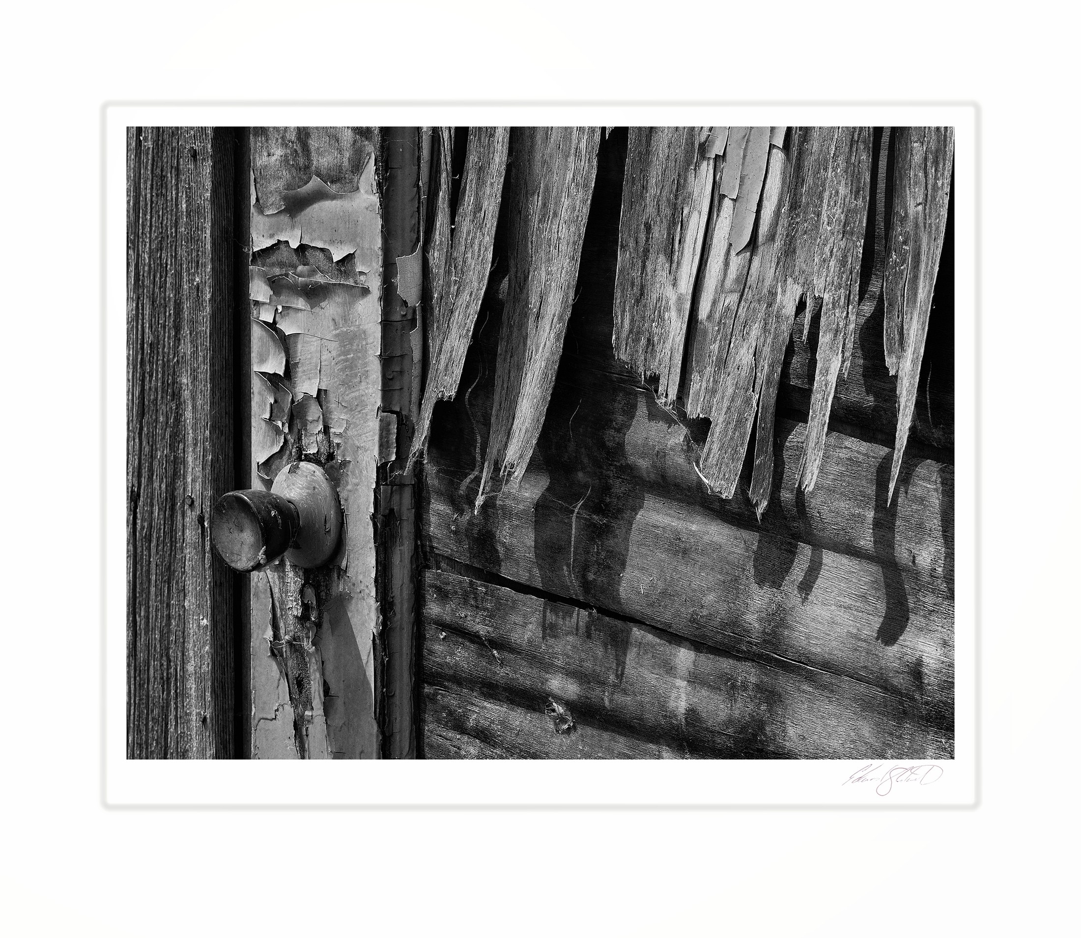 A weathered door with peeling paint and an old doorknob.